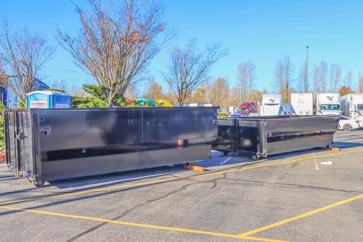 Professional dumpster rental service with roll-off container on residential driveway in Channahon